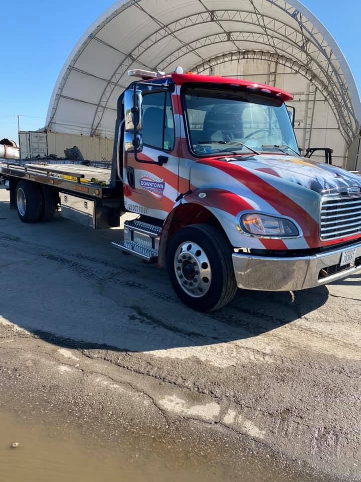 Downtown Recycling flatbed tow truck